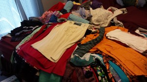 pile of clothes on a bed